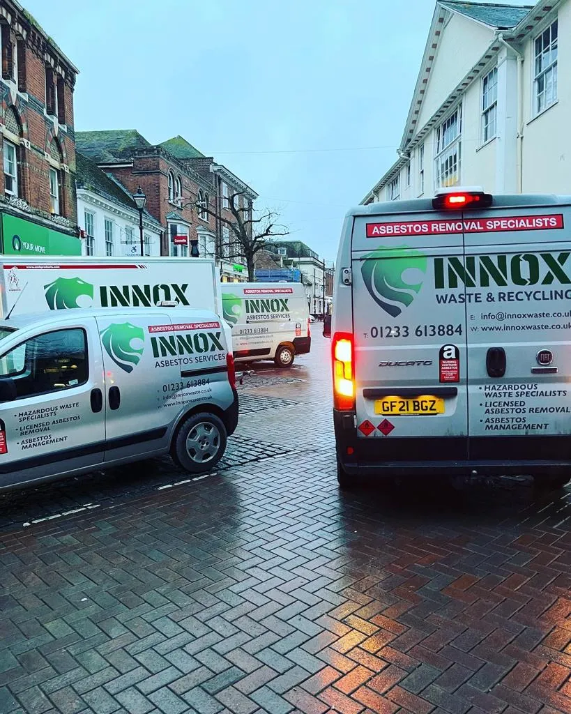 INNOX asbestos removal vans on a town high street